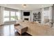 Bright living room with large windows, a fireplace, hardwood floors, and comfortable seating at 1071 Serenity Ct, Carmel, IN 46280
