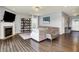 Open living room with a fireplace, hardwood floors, and neutral decor at 1071 Serenity Ct, Carmel, IN 46280