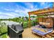 Wooden patio with outdoor furniture, a grill, and a view of the lake at 1071 Serenity Ct, Carmel, IN 46280