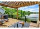 Relaxing patio with a grill, water view, string lights, and comfortable outdoor furniture at 1071 Serenity Ct, Carmel, IN 46280