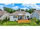 House featuring a wooden deck with a grill and patio furniture surrounded by lush green trees at 1071 Serenity Ct, Carmel, IN 46280