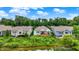 The backyard of lakeside houses features a nice deck overlooking green trees with a partly cloudy sky at 1071 Serenity Ct, Carmel, IN 46280