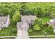 Stunning aerial view of a well-manicured suburban home with a lush green yard and mature trees at 10888 Weston Dr, Carmel, IN 46032