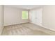 Empty bedroom with neutral carpet, a window, and a closet at 10888 Weston Dr, Carmel, IN 46032