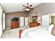 Spacious primary bedroom features a ceiling fan, dresser, and ensuite bath at 10888 Weston Dr, Carmel, IN 46032