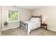 Bedroom with iron bed frame, window, and neutral carpet at 10888 Weston Dr, Carmel, IN 46032