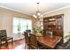 Charming dining room with hardwood floors, a wooden table, and a view of the backyard at 10888 Weston Dr, Carmel, IN 46032