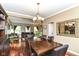 Elegant dining room with a wooden table, leather chairs, and a chandelier at 10888 Weston Dr, Carmel, IN 46032