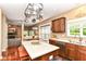 Open kitchen featuring stainless steel appliances, hardwood floors, and a central island with seating at 10888 Weston Dr, Carmel, IN 46032