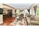 Cozy living room with hardwood floors, a comfortable sofa, and a view of the dining area at 10888 Weston Dr, Carmel, IN 46032