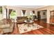 Inviting living room with hardwood floors, a plush sofa, and natural light at 10888 Weston Dr, Carmel, IN 46032