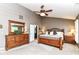 Spacious main bedroom featuring a ceiling fan, multiple windows, and a private ensuite bathroom at 10888 Weston Dr, Carmel, IN 46032
