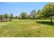 Backyard featuring a well-manicured lawn, shed, and mature trees at 1135 W Wildflower Ct, Mooresville, IN 46158