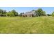 Backyard featuring a well-manicured lawn and side of the brick home at 1135 W Wildflower Ct, Mooresville, IN 46158