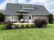 Backyard featuring a newly built deck with an outdoor seating area and landscaped flower beds and brick at 1135 W Wildflower Ct, Mooresville, IN 46158