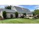 Backyard featuring a newly built deck with an outdoor seating area, manicured lawn, brick, and landscaping at 1135 W Wildflower Ct, Mooresville, IN 46158
