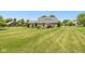 Backyard featuring a well-manicured lawn and back of the brick home at 1135 W Wildflower Ct, Mooresville, IN 46158