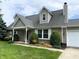 Charming brick home featuring dormer windows, well-manicured lawn and landscaping and a two-car garage at 1135 W Wildflower Ct, Mooresville, IN 46158