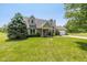 Charming two-story home with well-manicured lawn, dormer windows, and brick accents at 1135 W Wildflower Ct, Mooresville, IN 46158