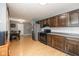 Well-lit kitchen with stainless steel appliances, dark cabinetry, and a dining area at 1135 W Wildflower Ct, Mooresville, IN 46158