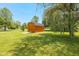 Wooden outbuilding with gray roof and light-colored ramp on manicured lawn beneath a blue sky at 1135 W Wildflower Ct, Mooresville, IN 46158