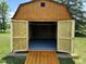 Open shed provides ample storage with a ramp, freshly painted walls and floor at 1135 W Wildflower Ct, Mooresville, IN 46158