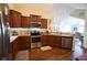 Well-lit kitchen with stainless steel appliances, ample counter space, and hardwood floors at 1150 Extraordinary Trl, Greenfield, IN 46140