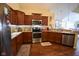 Well-equipped kitchen with stainless steel appliances, ample cabinet space, and wood floors at 1150 Extraordinary Trl, Greenfield, IN 46140