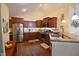 Bright kitchen with stainless steel appliances, hardwood floors and granite countertops at 1150 Extraordinary Trl, Greenfield, IN 46140