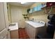 Functional laundry room with a washer, dryer, and convenient shelving for storage at 1150 Extraordinary Trl, Greenfield, IN 46140