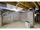 Exposed basement with unfinished brick foundation, floor, and a dehumidifier at 1150 W 30Th St, Indianapolis, IN 46208