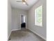 Bedroom features neutral carpet, gray walls, a ceiling fan, and a sun-filled window at 1150 W 30Th St, Indianapolis, IN 46208
