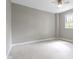 Spacious bedroom with neutral carpet, gray walls, and a sun-filled window at 1150 W 30Th St, Indianapolis, IN 46208