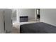 Bedroom with carpet floors and gray walls, featuring view into hall and closet at 1150 W 30Th St, Indianapolis, IN 46208