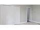 Bedroom features neutral carpet, gray walls, trim, and a closet with double doors at 1150 W 30Th St, Indianapolis, IN 46208