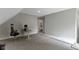 Bonus room featuring neutral carpet that leads to a tiled bathroom and outdoor access at 1150 W 30Th St, Indianapolis, IN 46208