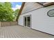 Deck with wood flooring offering outdoor living, sliding glass door, and unique windows at 1150 W 30Th St, Indianapolis, IN 46208