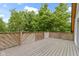 Spacious deck with wood flooring overlooking mature trees that offer privacy at 1150 W 30Th St, Indianapolis, IN 46208