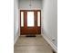 Bright Foyer with Hardwood Floors and Brown Front Door with Ornate Glass and Gray Walls at 1150 W 30Th St, Indianapolis, IN 46208