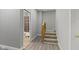 Hallway with carpeted stairs leading up and view into the bathroom with shower at 1150 W 30Th St, Indianapolis, IN 46208