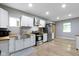 Well-lit kitchen features stainless steel appliances, butcher block counters, white cabinetry, and wood flooring at 1150 W 30Th St, Indianapolis, IN 46208