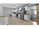 Bright kitchen features stainless steel appliances, butcher block counters, white cabinetry, and a stylish sliding door at 1150 W 30Th St, Indianapolis, IN 46208