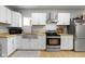 Well-lit kitchen features stainless steel appliances, butcher block counters, and a stainless steel farmhouse sink at 1150 W 30Th St, Indianapolis, IN 46208