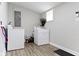 Bright laundry room with a white washer and dryer set and wood-look flooring at 1150 W 30Th St, Indianapolis, IN 46208