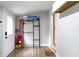 Mud room with storage rack, wood-look floors, and a door with decorative glass at 1150 W 30Th St, Indianapolis, IN 46208