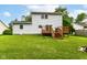 Large backyard features a wooden deck, grassy lawn, and privacy fence at 11612 E 75Th St, Indianapolis, IN 46236