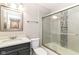 Bathroom with a stylish vanity, modern lighting, and tiled shower with glass door at 11612 E 75Th St, Indianapolis, IN 46236