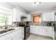 Bright kitchen featuring white cabinets, stainless steel appliances, and modern fixtures at 11612 E 75Th St, Indianapolis, IN 46236