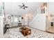 Bright living room featuring a fireplace, ceiling fan, and staircase at 11612 E 75Th St, Indianapolis, IN 46236