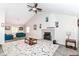 Spacious living room with vaulted ceiling, brick fireplace, ceiling fan, and contemporary furnishings at 11612 E 75Th St, Indianapolis, IN 46236
